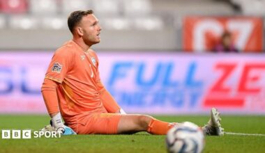 Daniel Peretz sits on the floor while on the pitch