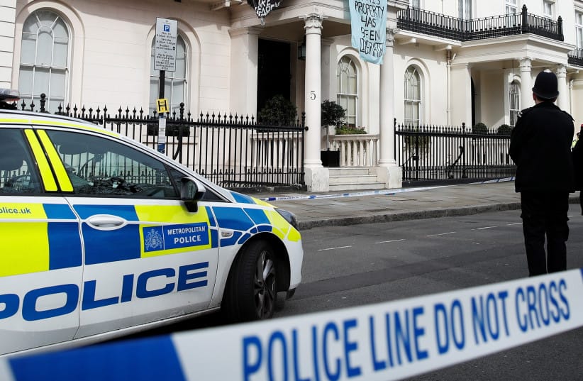 British police officers stand watch at crime scene
