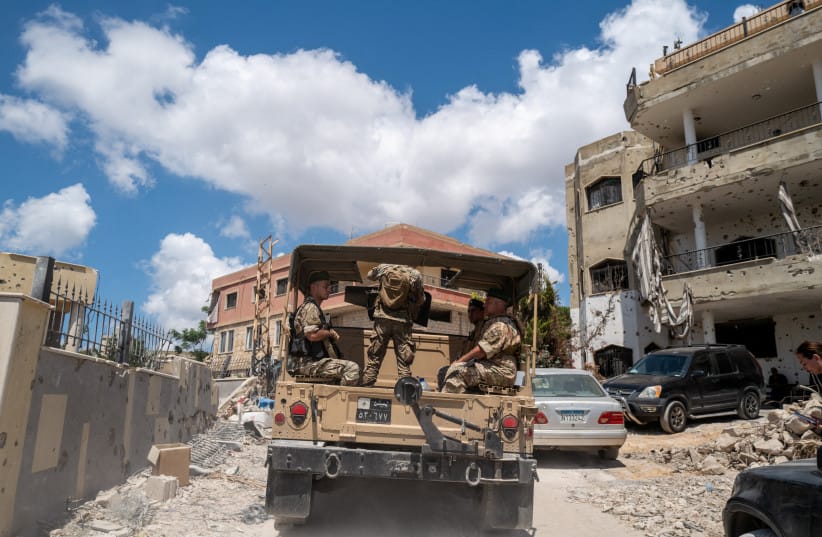 Lebanese army officers on a military vehicle drive in Zawtar al-Gharbiyeh, a village in southern Lebanon, following the deployment of Lebanese soldiers in one of three pilot zones after the withdrawal of Israeli forces under a US-brokered plan, July 26, 2026.