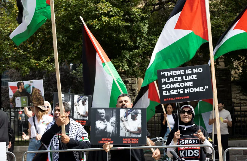 Pro-Palestinian protestors wave flags and signs across the street of the Roy Thomson Hall where the documentary ''The Road Between Us: The Ultimate Rescue'' is screened during the Toronto International Film Festival (TIFF) in Toronto, Ontario, on September 10, 2025; illustrative
