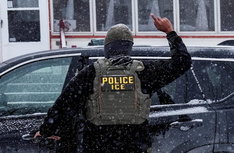 An Immigration and Customs Enforcement (ICE) agent raises a finger moments after detaining a man during an immigration raid, days after an ICE agent fatally shot Renee Nicole Good, in Minneapolis, Minnesota, U.S., January 18, 2026.