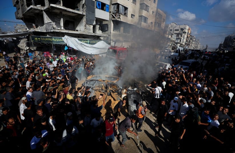 Palestinians attempt to extinguish a fire following an Israeli airstrike that hit a vehicle in Gaza City, September 19, 2026