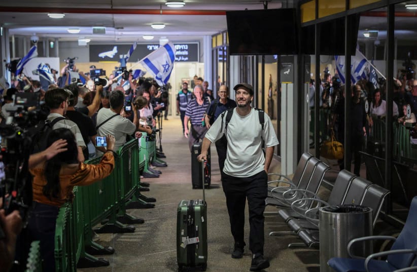 Passengers from Flydubai flight FZ1073 walk with their family members through the arrivals hall at Ben Gurion International Airport near Tel Aviv, after their original flight from Dubai to Israel was diverted to Saudi Arabia following a suspected terror attack, September 30, 2026.
