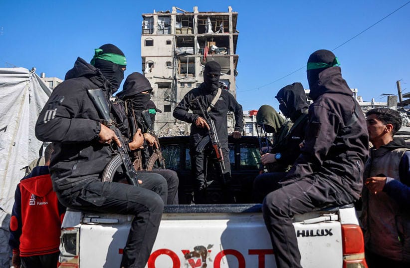 Hamas terrorists arrive to secure the area search for the last two remaining bodies of hostages - an Israeli soldier and a Thai national - from under the rubble of the Jabalia refugee camp, in the northern of Gaza Strip on December 1, 2025. as Egyptian workers accompanied by members of the ICRC 
