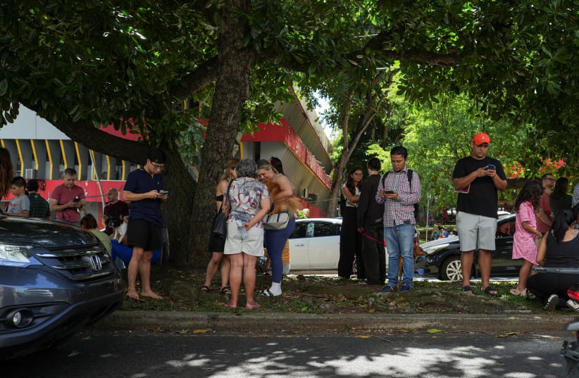 People gather in an open area after an earthquake struck near the southern coast of Panama, in Panama City, Panama, October 9, 2026.