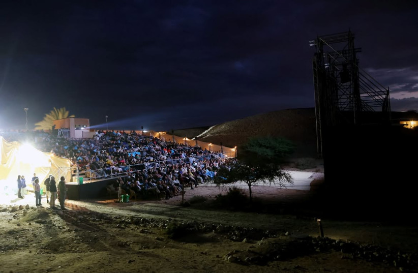 Moviegoers watch a screening under the stars in the Negev Desert during the 2025 Arava Film Festival.