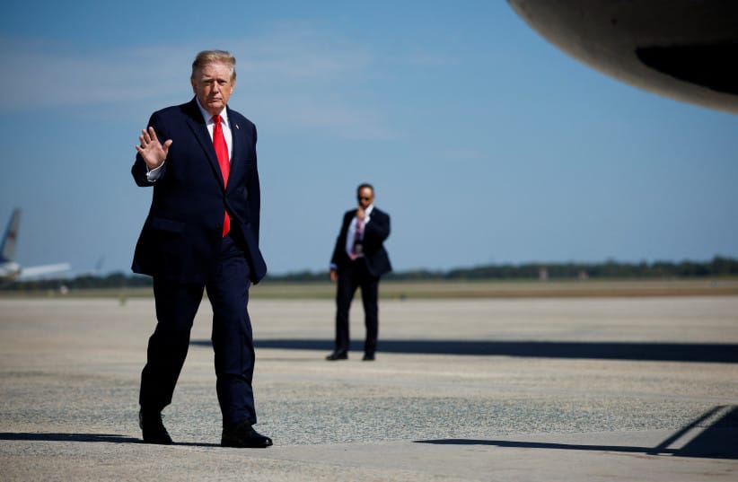 US President Donald Trump stands before boarding Air Force One for a trip to Alaska at Joint Base Andrews, Maryland, US, October 13, 2026