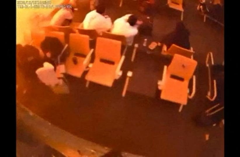 FILE PHOTO: Surveillance footage shows people sitting in a waiting area reacting at the moment of an attack, in a location given as King Khalid International Airport in Riyadh, Saudi Arabia, October 10, 2026, in this frame from a handout video.