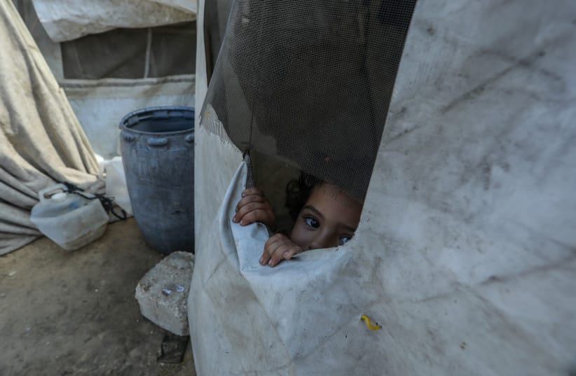 Displaced Palestinians live in a cemetery in central Khan Yunis, in the southern Gaza Strip, after being unable to return to their homes, which were destroyed during the war between Israel and Hamas, October 10, 2026.