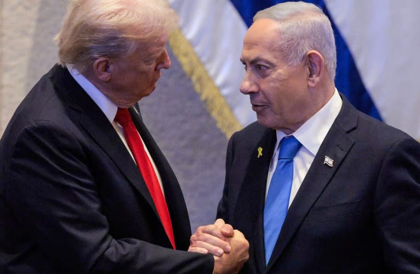 US President Donald Trump (L) holds hands and speaks with Israeli Prime Minister Benjamin Netanyahu at the Israeli parliament, the Knesset, in Jerusalem on October 13, 2025.