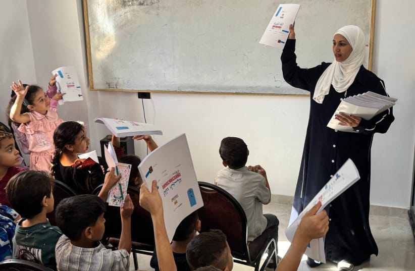 Palestinian teacher Hadeel Zourob teaches displaced children from Gaza at a school in El-Arish, Egypt, October 1, 2026. (Illustrative) (credit: Amr AHMED / AFP via Getty Images)