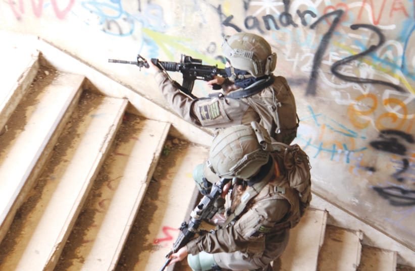 Female intelligence collection soldiers from Battalion 595 conduct a tactical exercise. The unit's soldiers combine field surveillance and drone technology to gather intelligence on threats operating near the northern border.