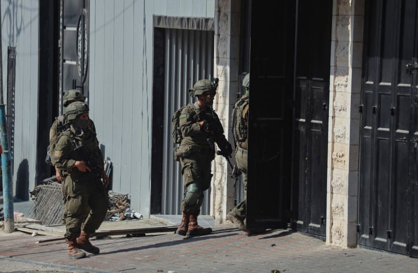 Israeli soldiers move near a building in Hebron, West Bank on October 23, 2026.