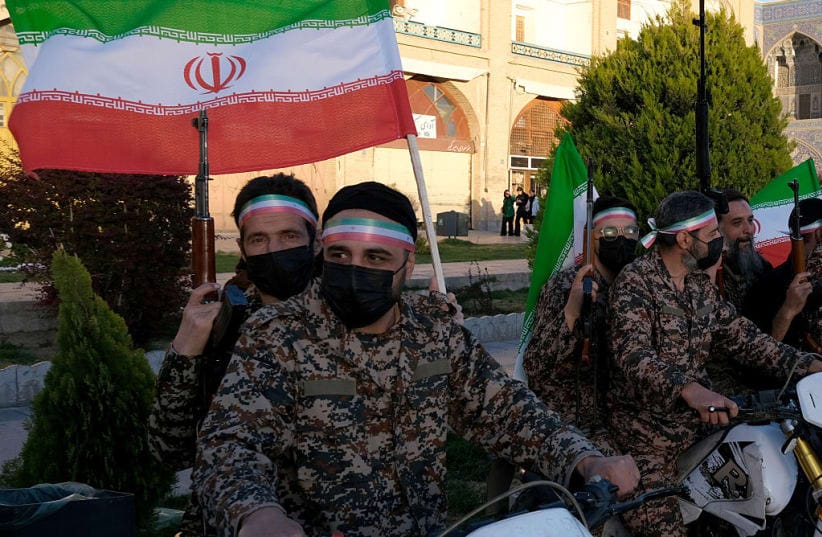 A group of Basiji (mobilized militia) men in military fatigue and armed seen in the middle of Naqsh-e Jahan Square mounted on their motorcycles on the occasion of Imam Reza's birthday while holding Iranian flags with images of the new Supreme Leader Mojtaba Khamenei on April 29, 2026.