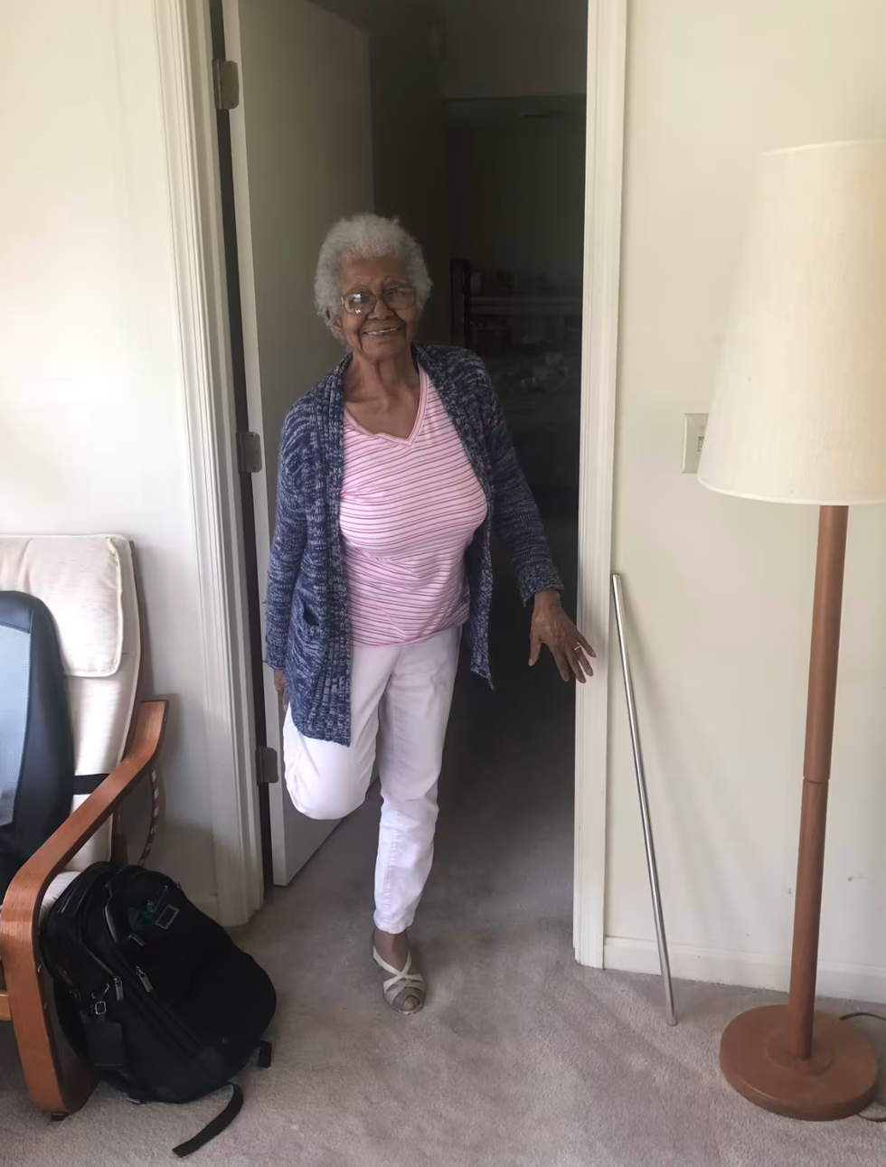 susan young browne 108 year old fitness routine: susan smiling while exercising her legs at home
