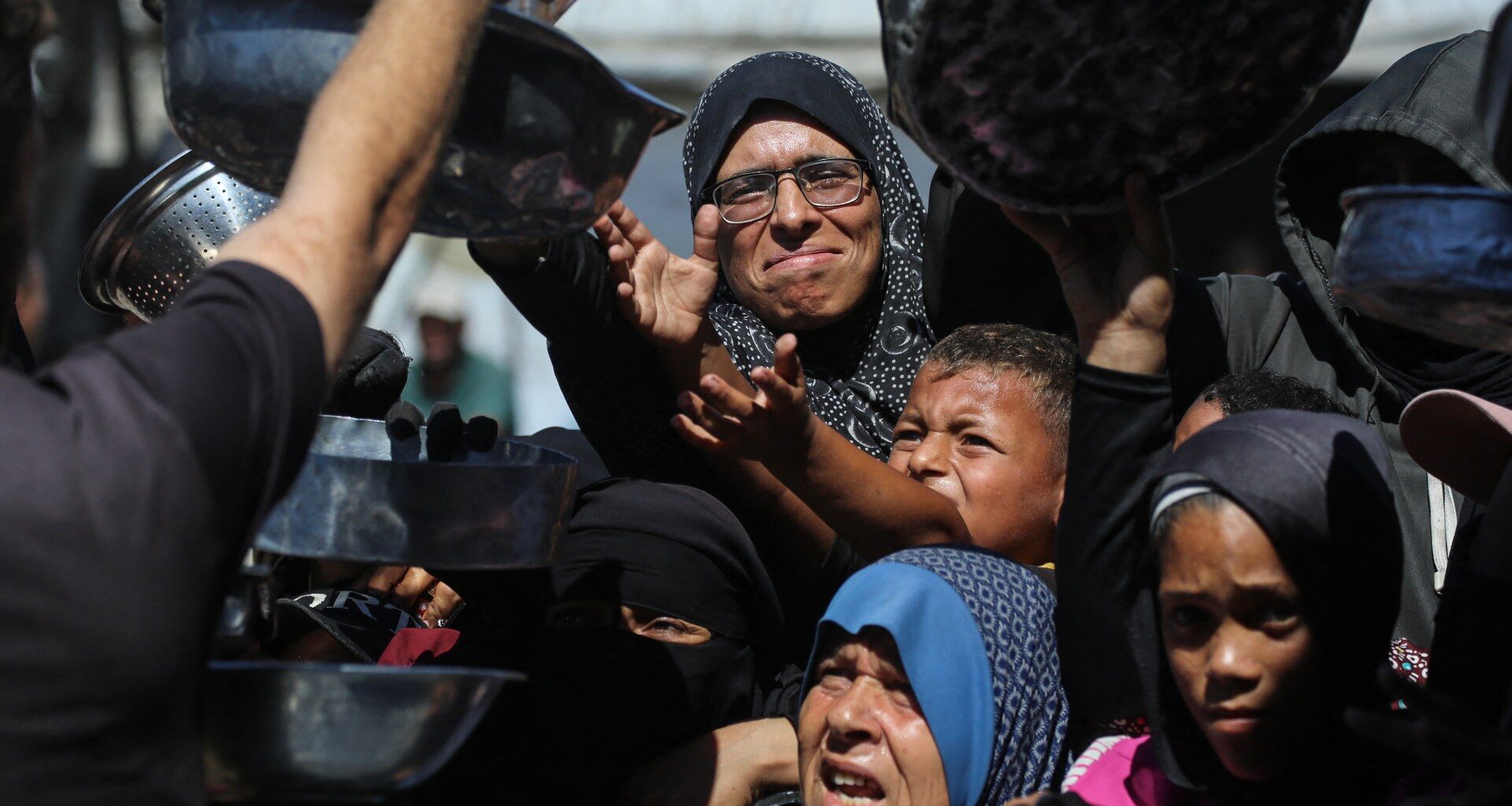 Photos: Gaza mothers endure endless lines as famine fears persist | Crimes Against Humanity News