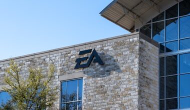 The EA logo on a stone building against a blue sky.