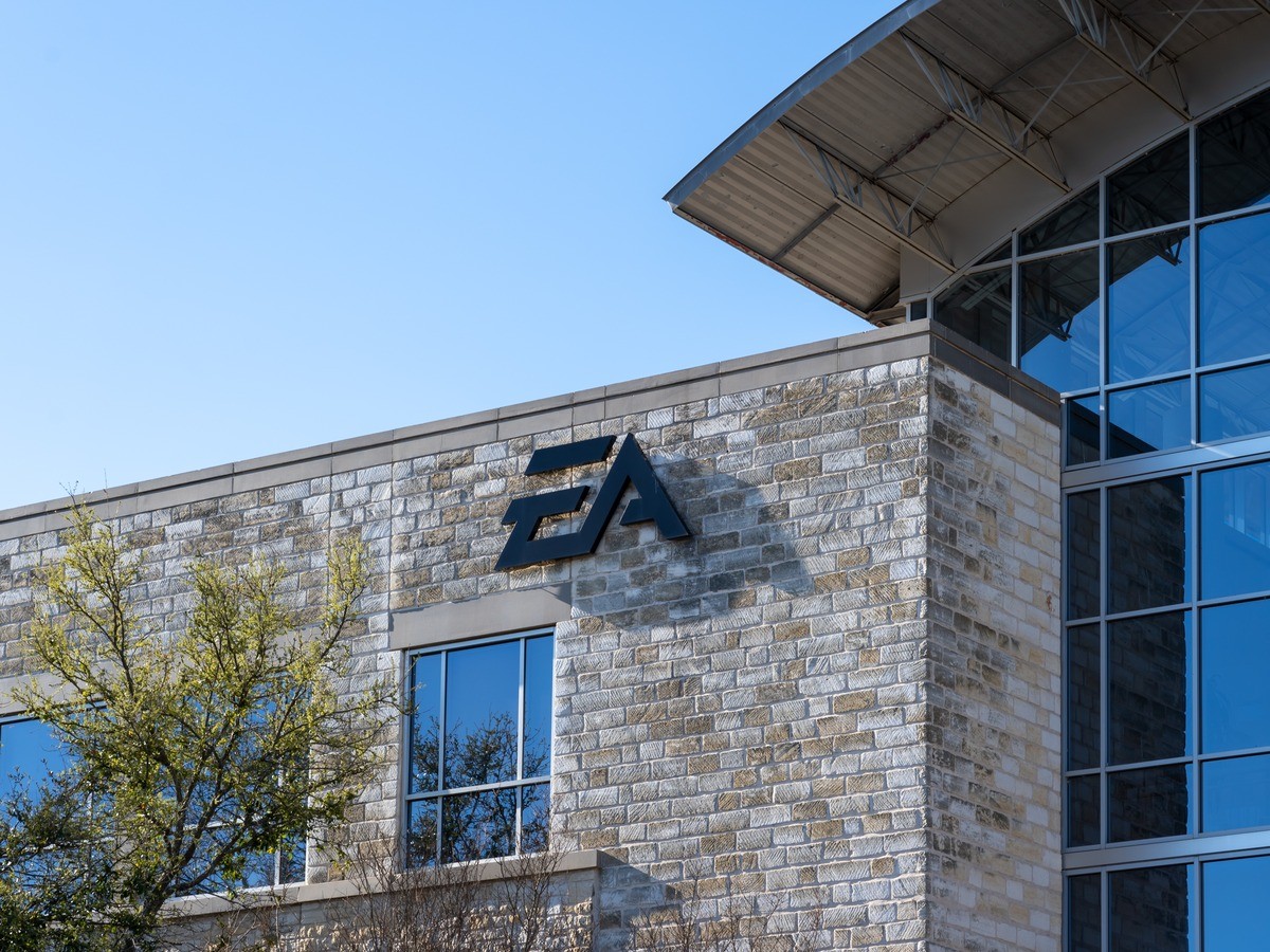The EA logo on a stone building against a blue sky.