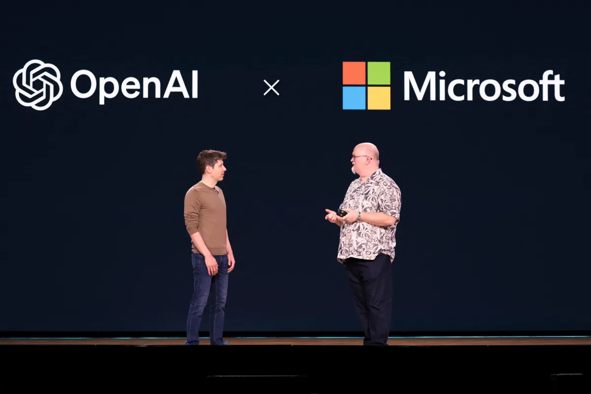 OpenAI CEO Sam Altman (L) speaks with Microsoft Chief Technology Officer and Executive VP of Artificial Intelligence Kevin Scott