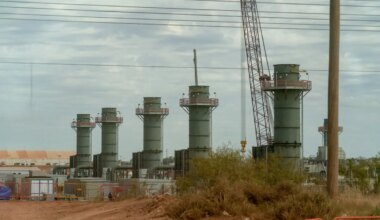 Five smoke stacks stand at a construction site in Texas.
