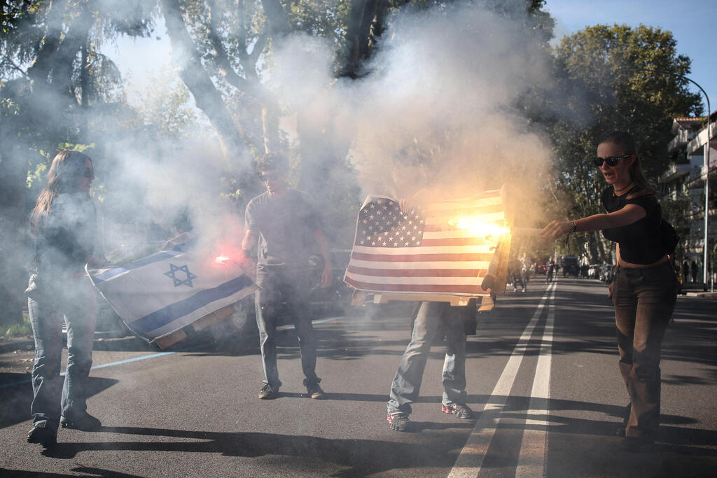In the heart of Rome: Protesters burn Israeli and US flags (Photo: REUTERS/Francesco Fotia) בלב רומא: מפגינים שרפו דגלי ישראל וארה"ב