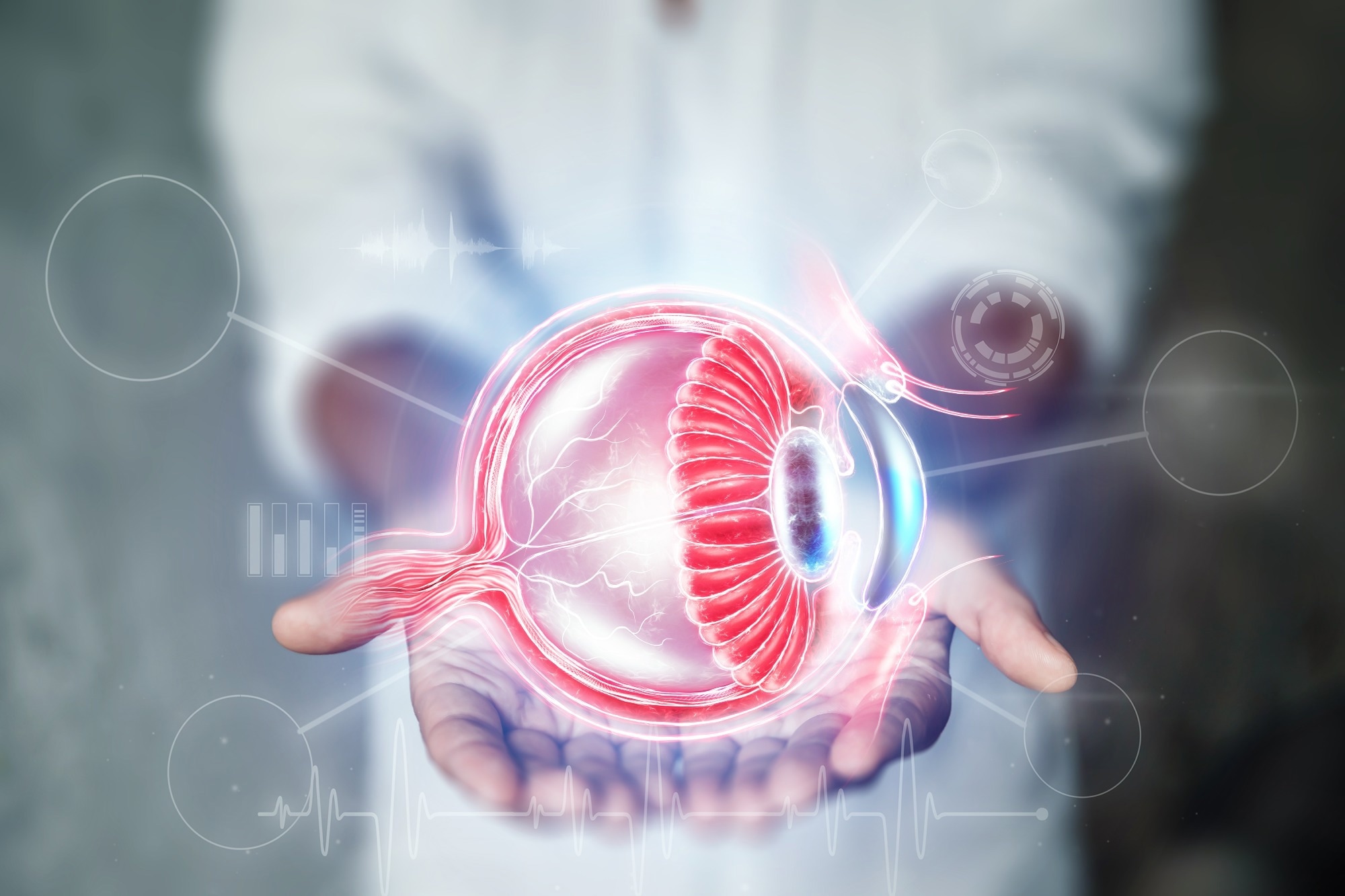Physician hands holding graphic of eye anatomy.