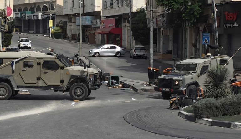 Israeli military vehicles in Hebron, which has been locked down since an attack on Friday on Israeli soldiers