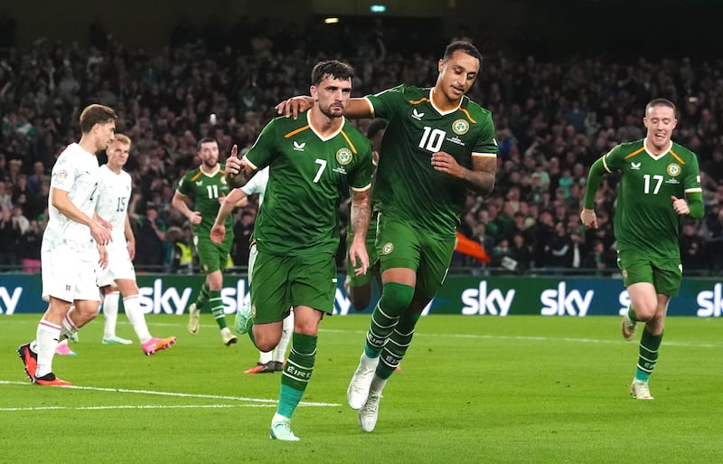 Troy Parrott celebrates with Adam Idah after scoring Ireland's second goal from a penalty against Austria. Photograph: Brian Lawless/PA
