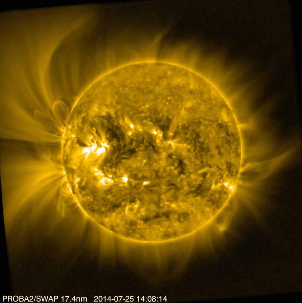 Image of the sun in mostly yellow tones on a dark background.