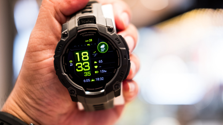 A Garmin smartwatch with metrics on the display