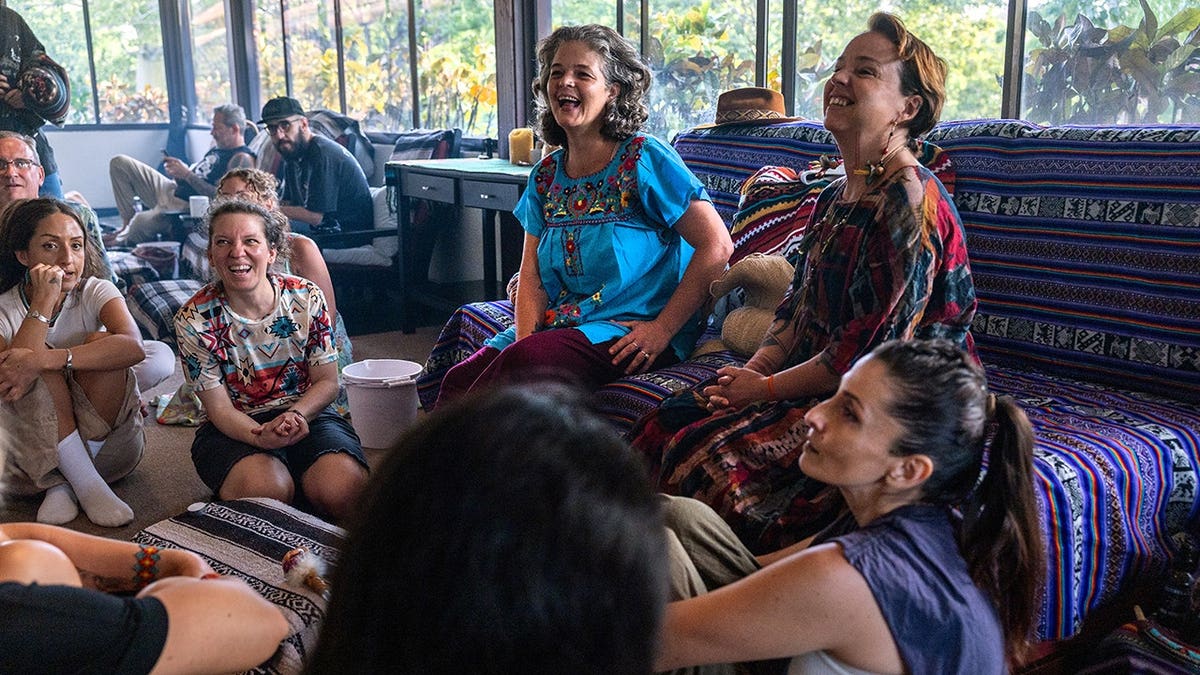 Female shaman Ananta speaks with medicine facilitators before an ayahuasca ceremony.