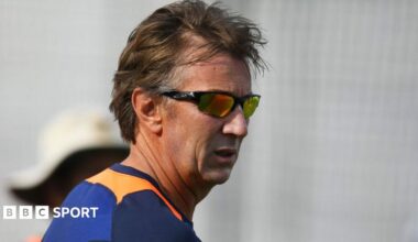 A headshot of Eric Simons wearing sunglasses
