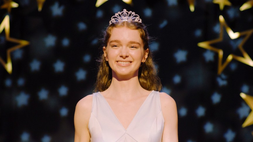 Summer H. Howell stands in a gown and tiara in a production still from Carrie on Prime Video.