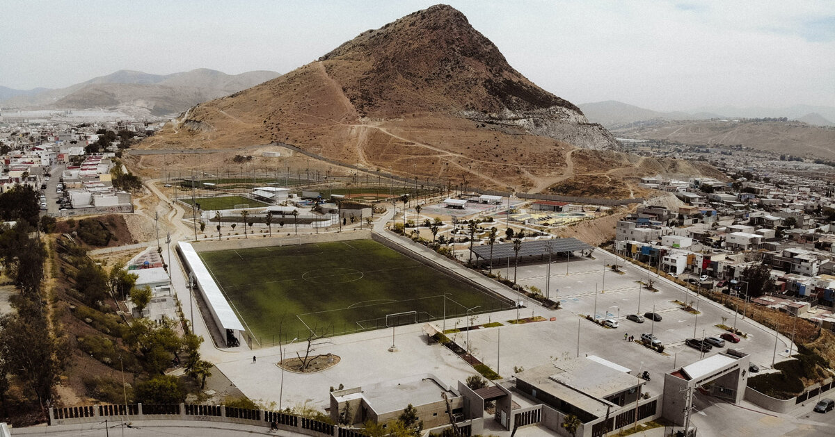 open fields and concrete paths create shared sports landscape in tijuana