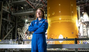 NASA astronaut Christina Koch stands inside Kennedy Space Center’s Vehicle Assembly Building on July 14, 2021, in front of the agency’s Space Launch System (SLS) rocket that ultimately powered the Orion spacecraft on the Artemis I mission. Koch later served as a crew member on the Artemis II mission in 2026, and on Oct. 13, 2026, NASA announced she will serve next as the agency’s acting deputy chief engineer.