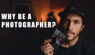 Man in a black cap holding a black rangefinder camera, with the title 'Why Be a Photographer?' overlaid on the left