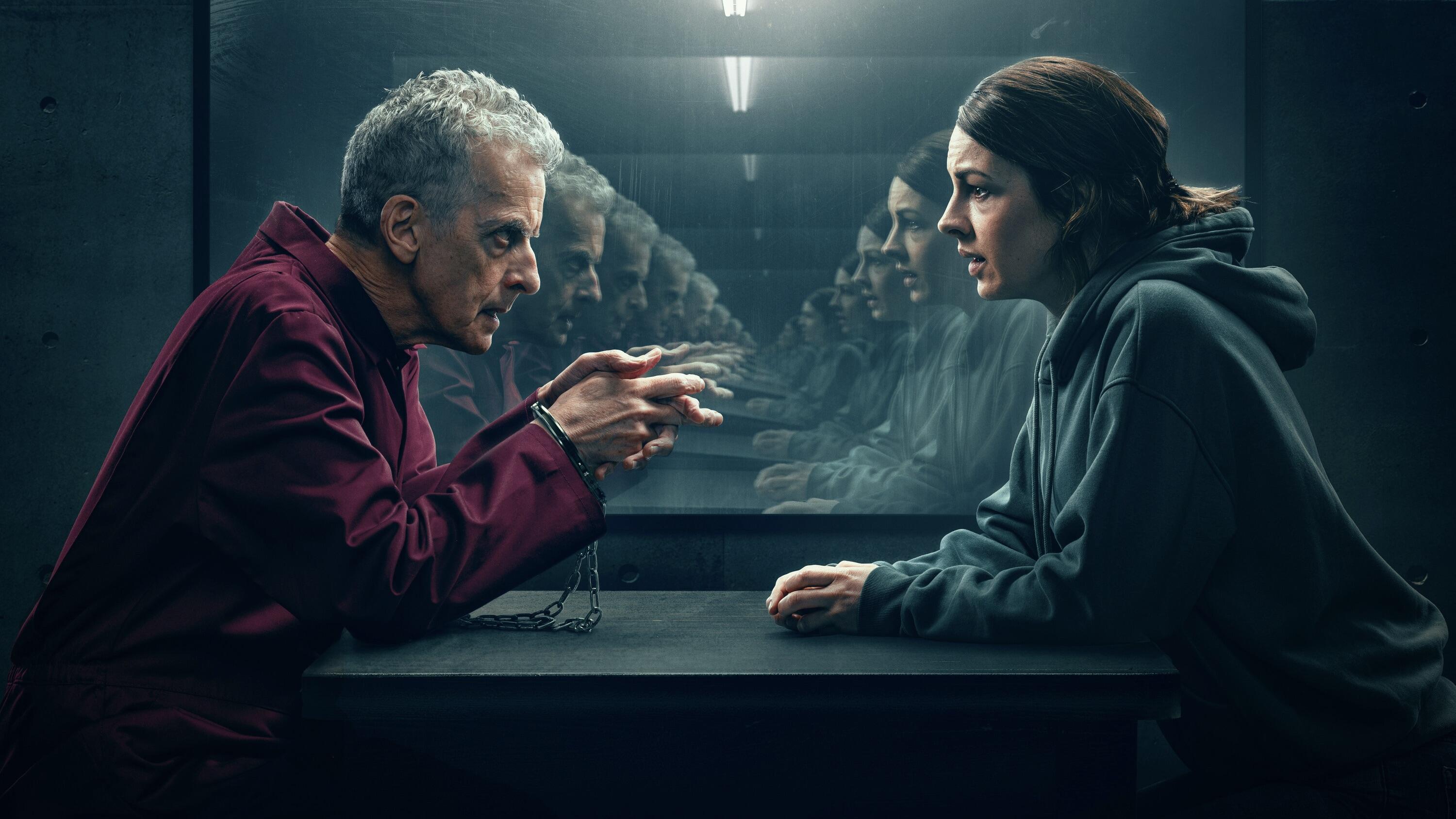 Peter Capaldi and Jessica Raine sit opposite each other in a production still from The Devil's Hour.