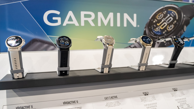 Several Garmin smartwatch models on display in a store