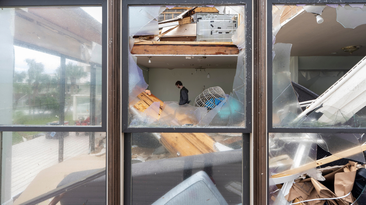 Alex Dean cleans out his home that was severely damaged during Hurricane Isaias. Hurricane Isaias made landfall Friday, October 9 along the U.S. Gulf coast.