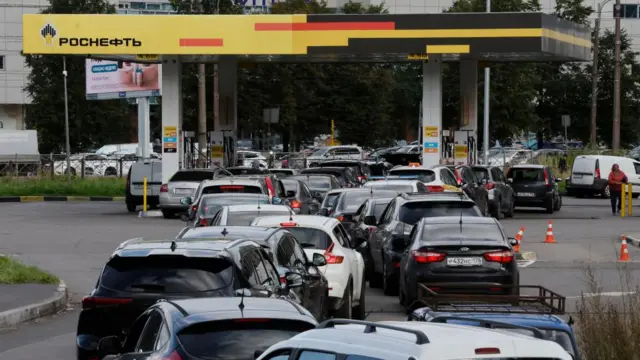 Cars queue outside a Rosneft petrol station in St Petersburg