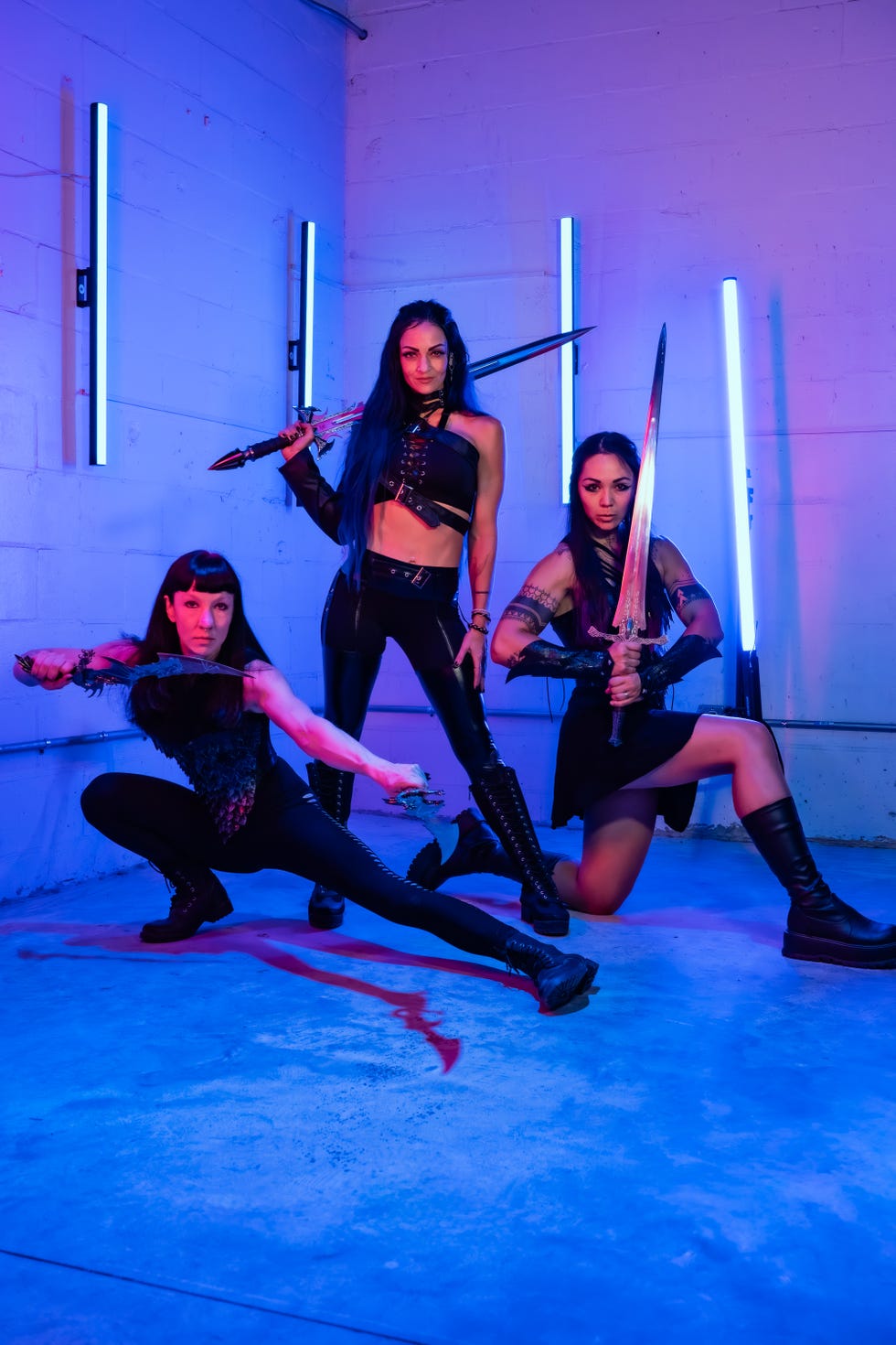 Whimsy Forge founder Charity LeBlanc and two other Whimsy Forge trainers doing romantasy-inspired fitness