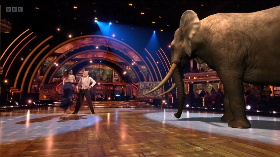 Strictly Come Dancing elephant strictly, bill bailey and oti mabuse dance on stage with a cgi elephant to the right of them