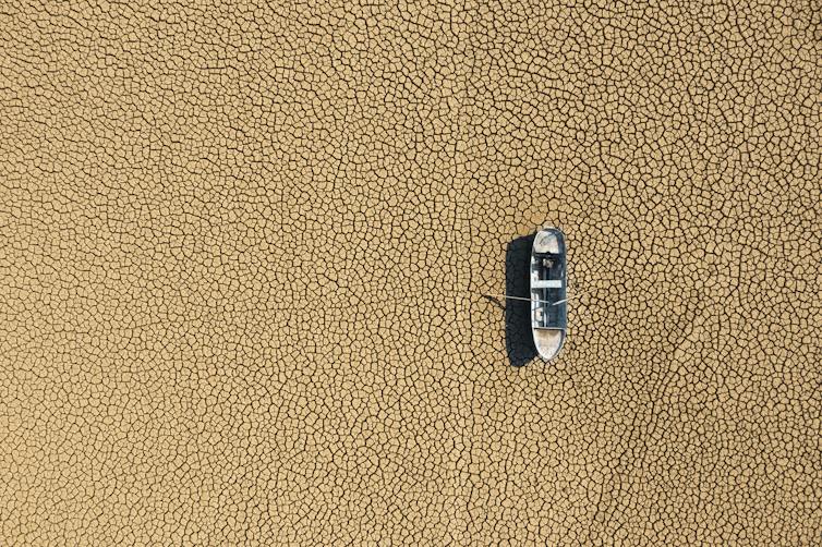 boat high and dry on lake bed.