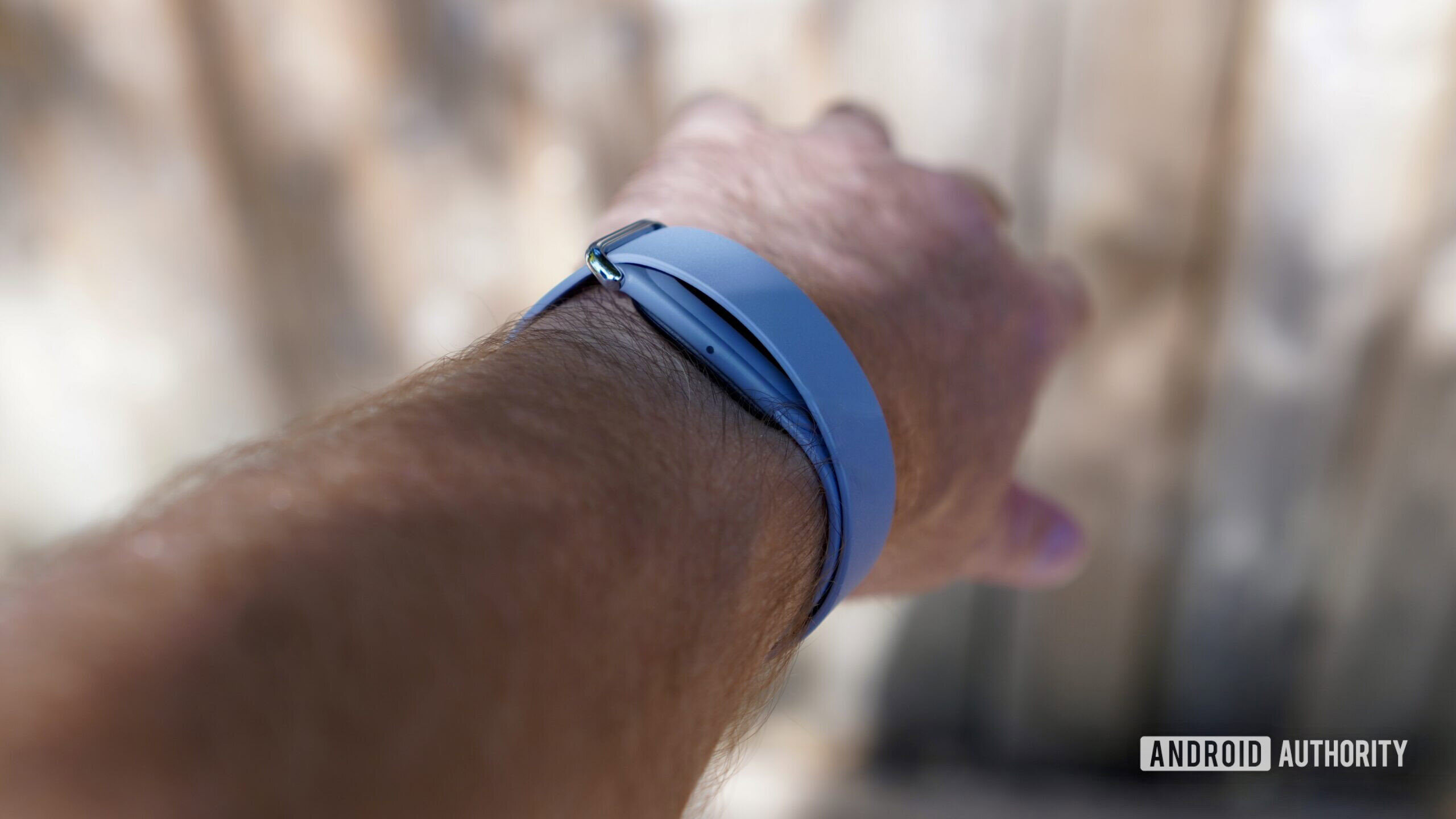 A person wearing a Fitbit Air, showing the side of the device.