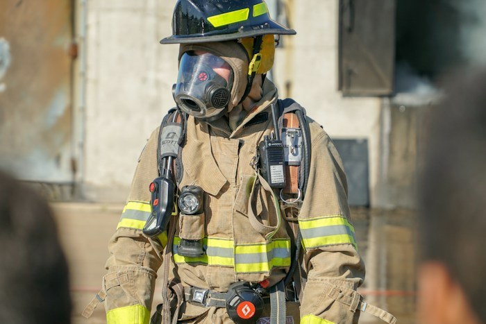 A firefighter standing in full gear, representing unique dumpster finds salvaged from local places.