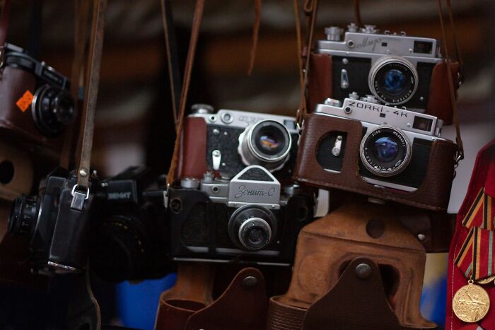 Collection of vintage film cameras in leather cases as dumpster finds