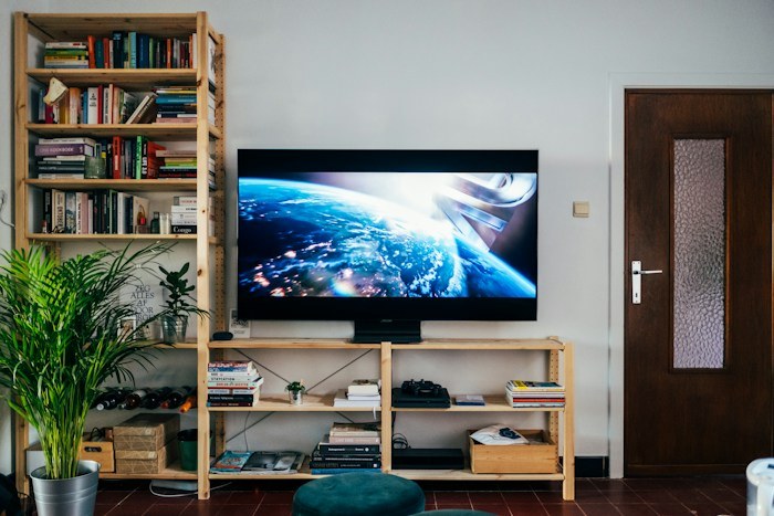 Large flat screen TV on a wooden console table, one of the best dumpster finds.