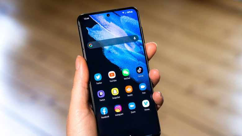 A hand holding a Samsung Galaxy phone.
