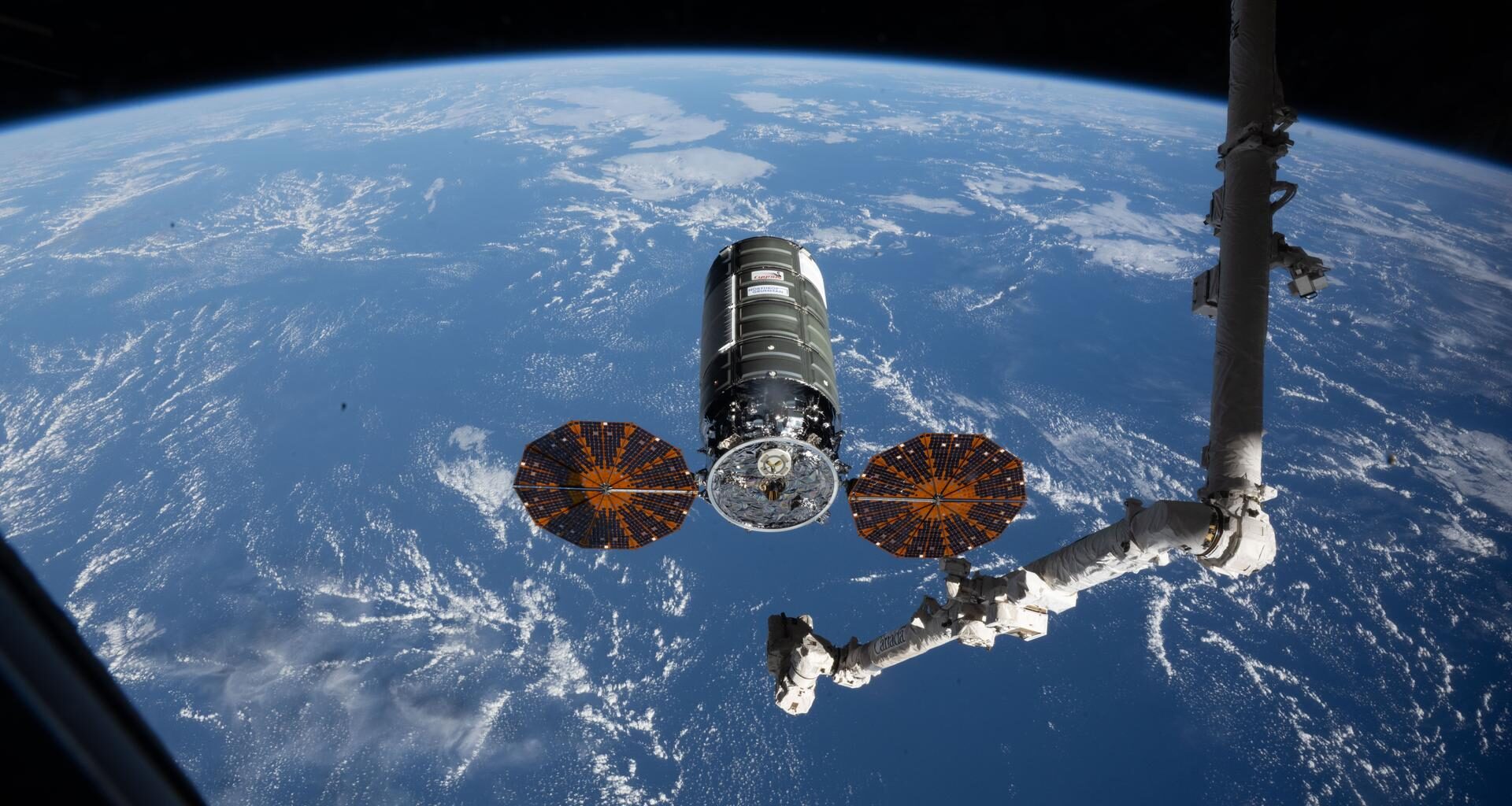 iss074e0458241 (April 13, 2026) --- Northrop Grumman's Cygnus XL cargo spacecraft rests at its capture point, 12 meters from the International Space Station, as the Canadarm2 robotic arm prepares to grapple the resupply ship. Cygnus XL delivered more than 11,000 pounds of new science experiments, lab hardware, and crew supplies for the Expedition 74 crew.