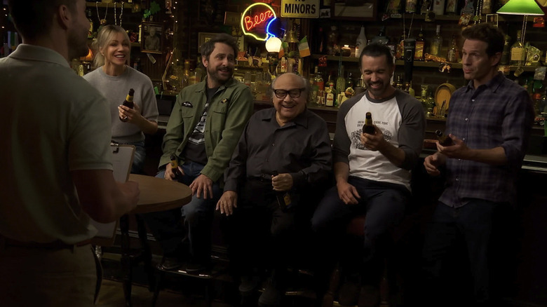 The gang seated at the bar laughing and drinking beer in It's Always Sunny Season 18